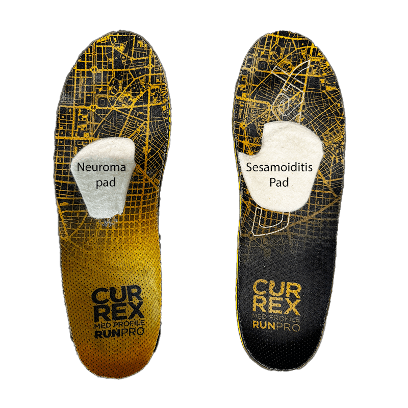 A pair of yellow and black insoles on top of a green background.